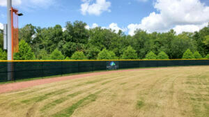 black ExtremeScreen and yellow athletic fence guard on sports field