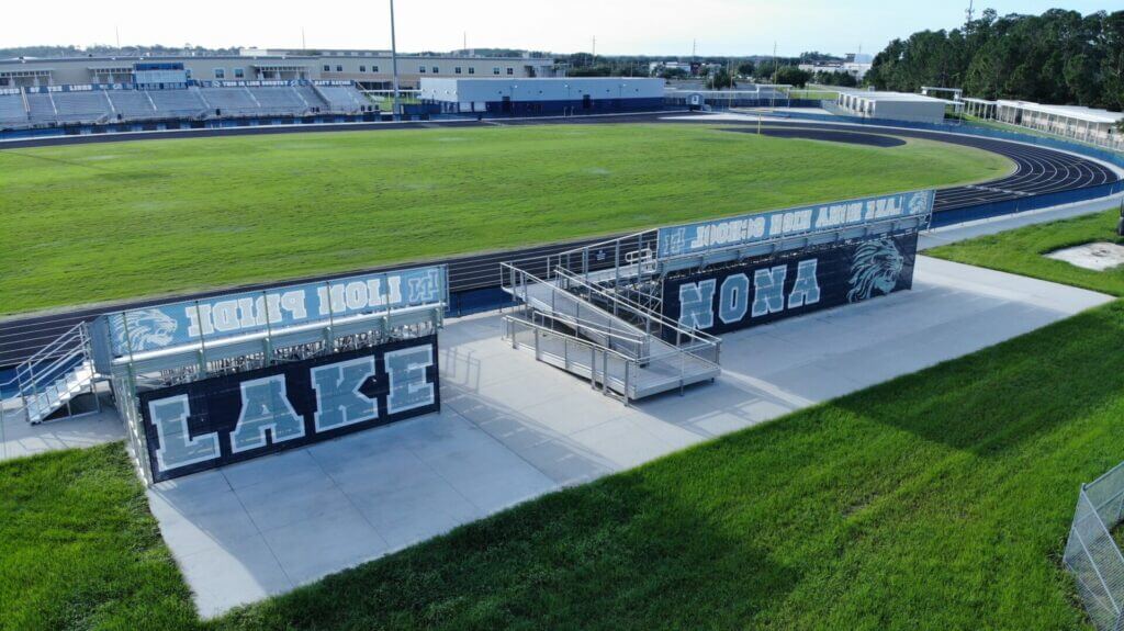 blue branded Bleacher Wraps Digital Printing and graphics on athletic field