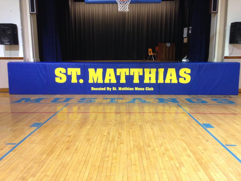 blue wall padding with yellow branding for sports event