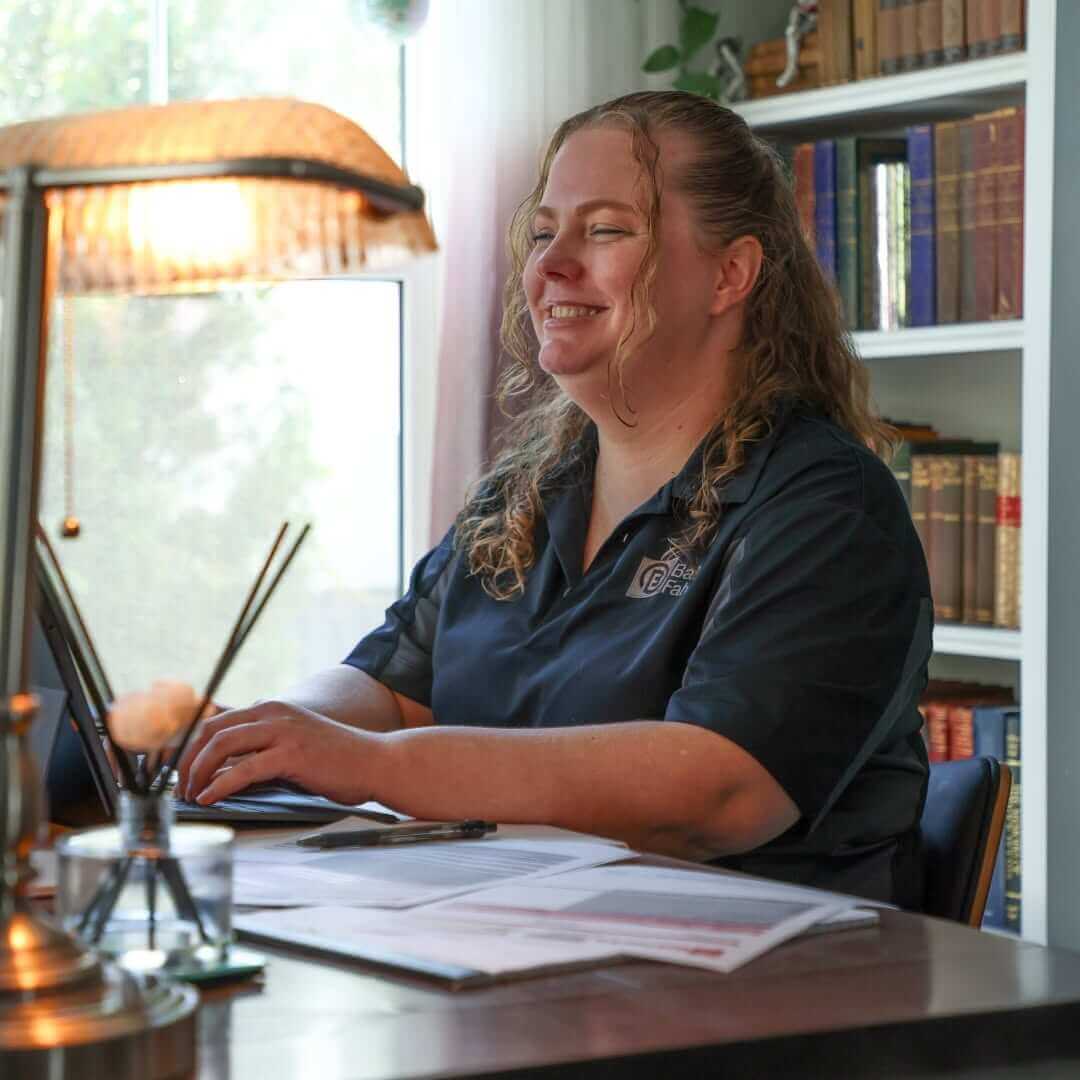A Ball Fabrics employee in the office on a computer.